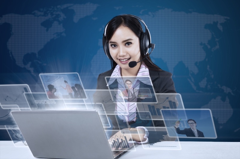 A businesswoman uses a virtual receptionist phone system